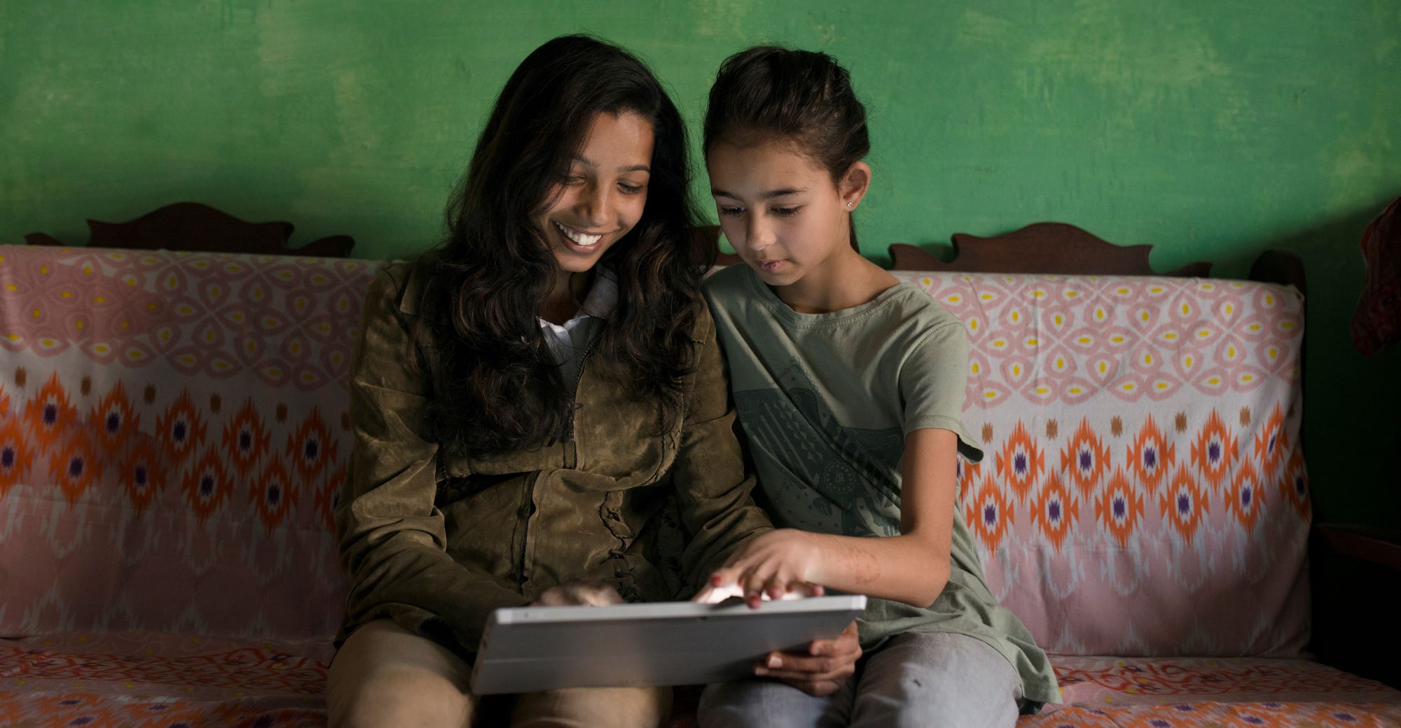 Girl and aunt looking at screen